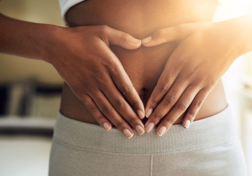 Frau hält Bauch – Blähbauch und Darmgesundheit natürlich verbessern